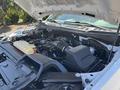 A 2019 Ford F-150 engine bay showcasing the engine components and fluid reservoirs with the hood open