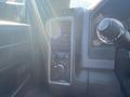 Interior control panel of a 2015 RAM 2500 featuring air conditioning vents and a dial for adjusting settings
