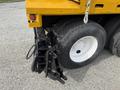A close-up of the rear assembly of a 2016 International 7600 truck featuring dual tires and a black mounting bracket attached to the rear frame