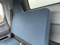 A large blue seat back of a 2012 Mitsubishi Fuso FE truck without visible seat cushions or seatbelts