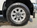 Close-up of a silver wheel and tire from a 2020 Ford F-350 SD showcasing the rugged tread design and shiny alloy rim