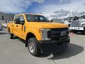 A 2017 Ford F-250 SD in bright yellow with a large front grille and rugged tires parked in a lot