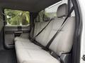 A 2020 Ford F-550 with a spacious rear seat featuring gray fabric upholstery and safety seat belts