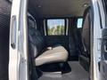 Interior view of a 2005 GMC C7500 Topkick showing a single row of grey seating with two seats and a simple dashboard visible in the front cabin area