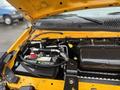 Close-up view of the engine compartment of a 2021 Ford Econoline showcasing the battery and various engine components