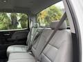 Interior view of the rear seating area of a 2016 GMC Sierra 1500 with gray fabric seats and seatbelts attached