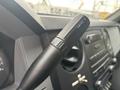 Close-up of the gear shift lever in a 2014 Ford F-550 with a black handle and control buttons for towing functions