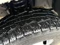 Close-up of a wet tire on a 2008 Ford F-350 showcasing deep treads and grooves for traction