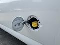 Close-up of the fuel cap on a 2021 Chevrolet Express revealing the yellow fuel filler neck inside