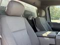 Interior of a 2019 Ford F-550 showing two gray fabric seats with headrests and a center console between them