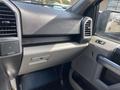 Interior view of a 2015 Ford F-150 dashboard showing the glove compartment and control panel details