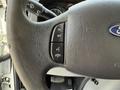 Close-up of a Ford E-450 steering wheel with buttons for cruise control and hands-free calling