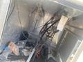 A 2010 aluminum 16-foot boat showcasing its interior filled with various wires tools and debris