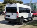 A 2022 RAM Promaster 350 van with a white exterior and black accents featuring a wheelchair accessible ramp on the side and a raised rear design