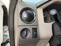 The dashboard control panel of a 2010 Ford F-550 featuring knobs for air circulation and headlight settings