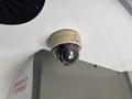 A ceiling-mounted surveillance camera labeled SEON is installed in a vehicle interior