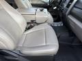 Interior of a 2020 Ford F-550 featuring beige leather front seats with a central console and cup holder