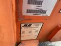 A 2009 JLG E300AJP aerial lift with identification labels and patent information on the side of the equipment