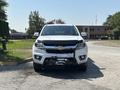 A white 2017 Chevrolet Colorado pickup truck is prominently displayed facing forward with a black grill and a winch attached to the front bumper