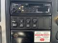 Dashboard controls of a 2006 International 4300 including a radio and several switches for various functions
