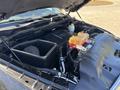 A 2015 RAM 1500 engine bay featuring an air intake system a coolant reservoir and various engine components. The engine is clean and well-maintained