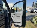 A 2016 Ford Transit 150 is shown with the driver's side door open revealing the interior features and door panel design