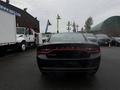 A black 2017 Dodge Charger viewed from the rear showing its sleek design and distinctive taillights