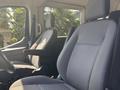 Interior of a 2025 Ford Transit T-350 showing front seats with seatbelts and modern fabric upholstery