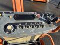Control panel of a 2012 JLG E400AJFN aerial lift featuring buttons levers and indicators for operating the equipment