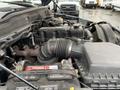 Engine compartment of a 2006 Dodge Ram 2500 showing the air intake hose battery and engine components