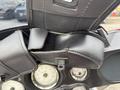Close-up of the handlebar of a 2009 Harley-Davidson Road King featuring black leather grips and instrument dials displaying speed and fuel levels