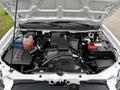 The engine compartment of a 2011 Chevrolet Colorado showing the engine, air intake, battery, and various components and fluids