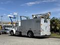 A 2009 Kenworth T270 utility truck with a large silver service body and a mounted lift boom on top