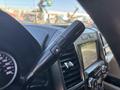 Close-up of the gear shift lever of a 2019 Ford F-550 featuring controls for transmission settings and a digital display in the background