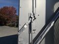 A close-up of the door handle mechanism on a 2008 International 4400 truck showing a metallic lever and latch system