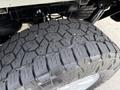 Close-up of a treaded tire from a 2021 Ford F-150 showcasing deep grooves and rugged pattern designed for off-road performance