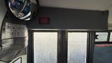 2021 Ford Transit interior view showing a rearview mirror and emergency exit signage on the interior wall