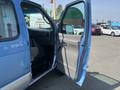 A blue 2005 Ford Econoline with a partially open passenger door revealing the interior seating and dashboard
