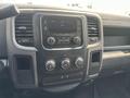 The dashboard of a 2015 RAM 1500 featuring a central display with radio controls and climate control knobs