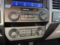 The image shows the dashboard controls of a 2021 Ford F-250 SD including audio and climate control buttons