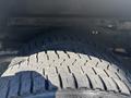 Close-up of a tire from a 2012 Ford E-450 showing detailed tread pattern and texture