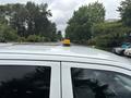A 2013 RAM 1500 with a yellow emergency beacon mounted on the roof