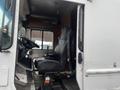 The interior of a 2012 Workhorse W62 featuring a black driver's seat and steering wheel with controls visible in the cab
