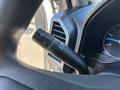 Close-up of the control stalk for turn signals and wipers in a 2019 Ford F-550 featuring various settings and indicators