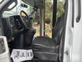 Interior of a 2020 Chevrolet Express showing the driver's seat dashboard and steering wheel with a black leather seat