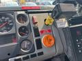 Interior dashboard of a 1999 Freightliner FL80 showing gauges buttons and warning lights