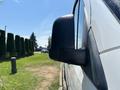 A 2019 Mercedes-Benz Sprinter van is shown from the side highlighting the black side mirror and part of the white vehicle body