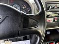 Close-up of a steering wheel with controls for cruise and resume settings in a 2012 International DuraStar 4300 truck interior