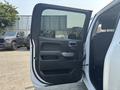 A 2017 Chevrolet Silverado 1500 with the front door open showcasing the interior door panel and handle
