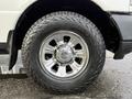 A close-up of a chrome wheel and tire of a 2011 Ford Ranger showcasing a shiny rim and rugged tread on the tire